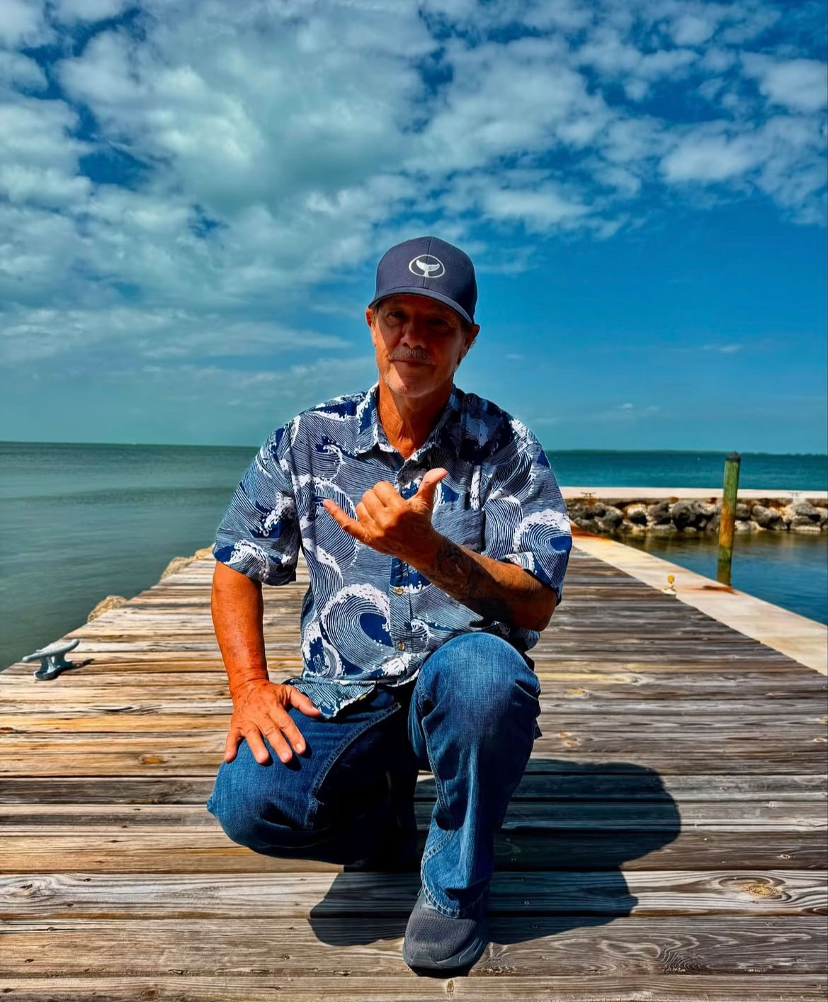 Wyland-on-dock Wyland on a dock with the ocean behind him
